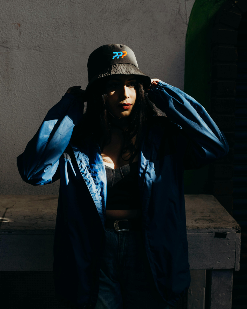 Model wearing Black Power Plays Playbook logo bucket hat